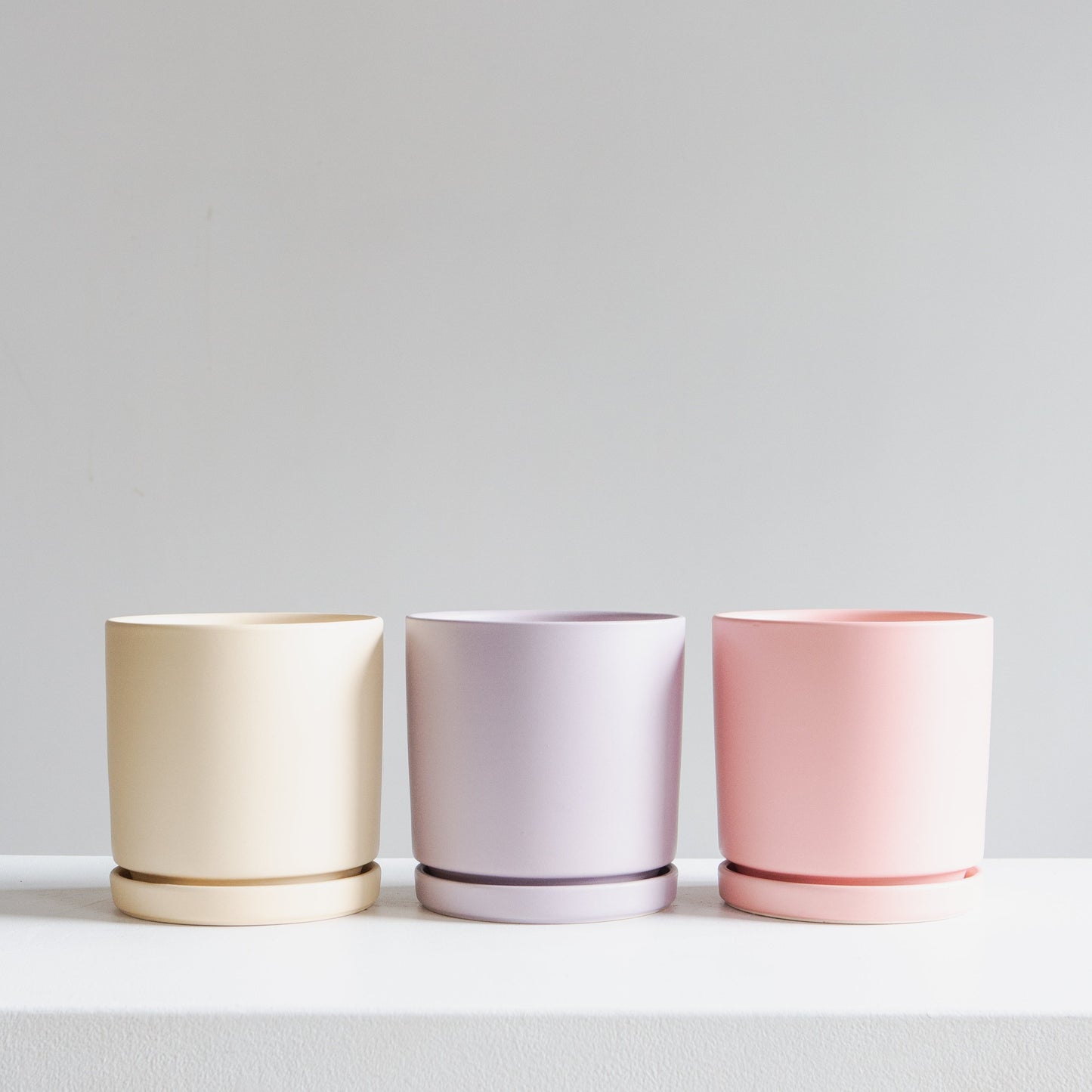 Almond Cylinder Planter with Drainage and Tray | 6.5 inch Diameter — empty planter, studio photo — planter for sale by Promise Supply for delivery and pickup in Toronto.