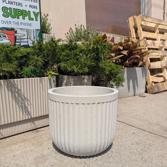 Flute Round Poly Planter in Sandstone | 12 Inch Nursery Pot — empty planter, studio photo — planter for sale by Promise Supply for delivery and pickup in Toronto.
