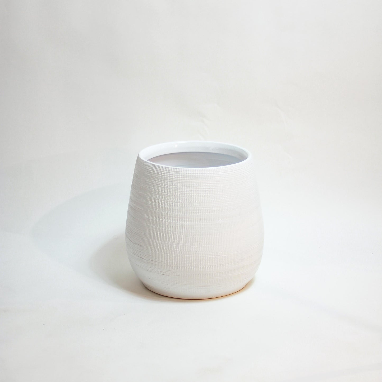 White Benji Ceramic Planter | 7 inch Nursery Pot — empty planter, ceramic planter, studio photo — planter for sale by Promise Supply for delivery and pickup in Toronto.