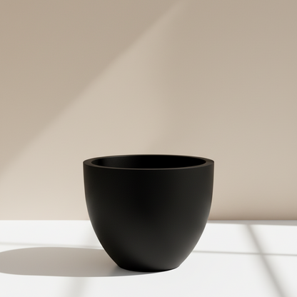 Hi end Black pot made of fiberglass on a white surface with a beige background
